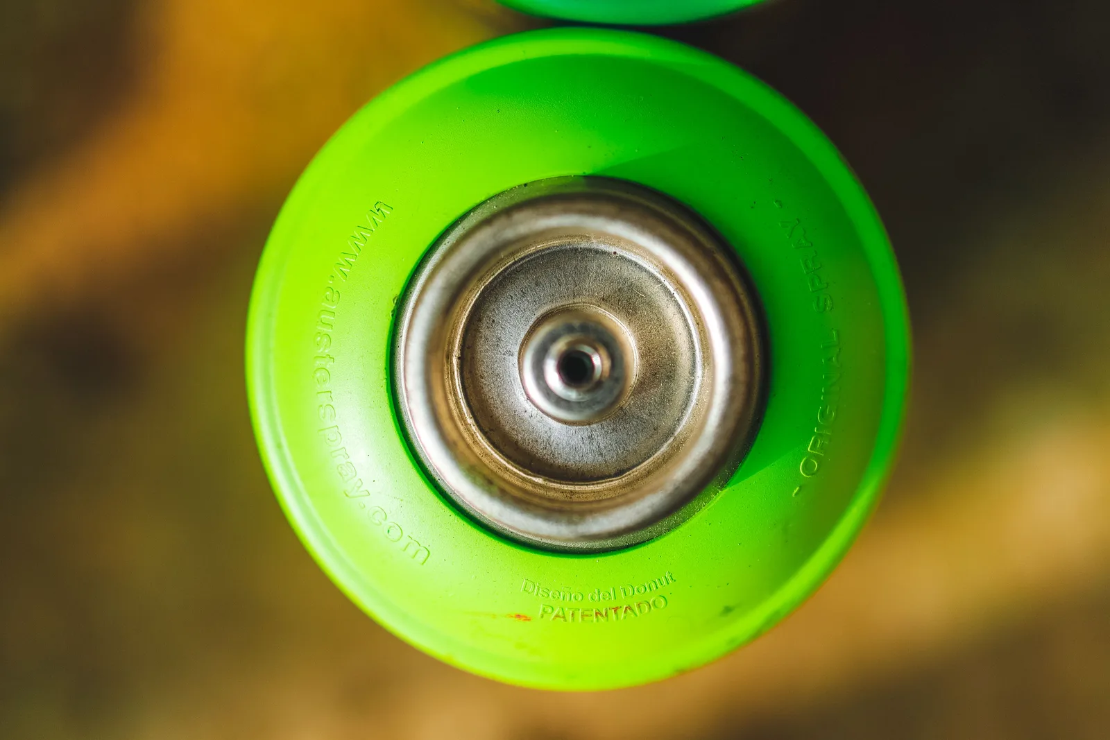 Detailed overhead view of a green spray paint can with visible branding. Quality control in a parking lot striping business: how owners check the work